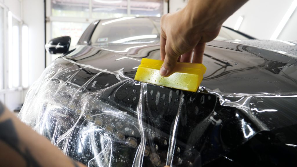 Installer applying ppf to a vehicle