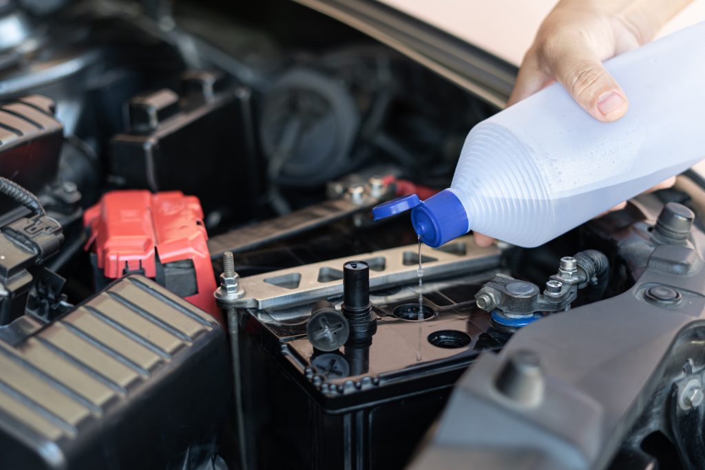 Pouring solution on a car battery