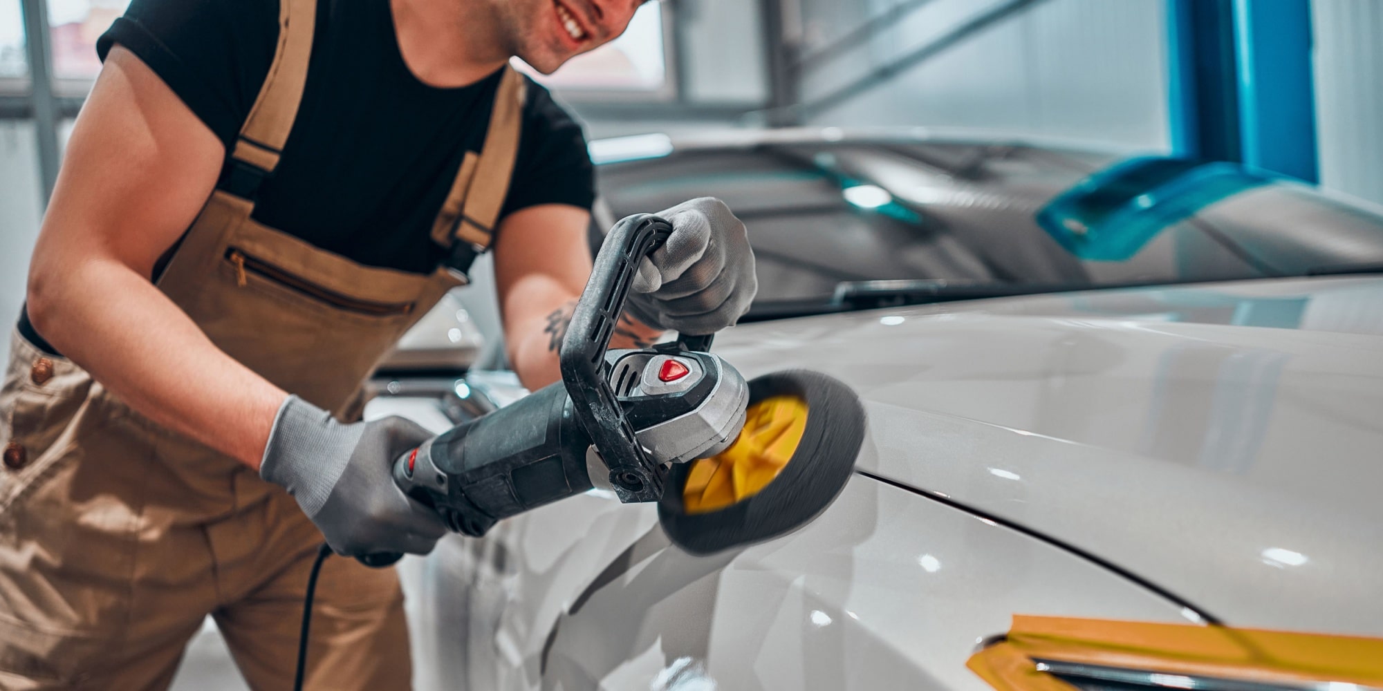man doing paint correction and detailing